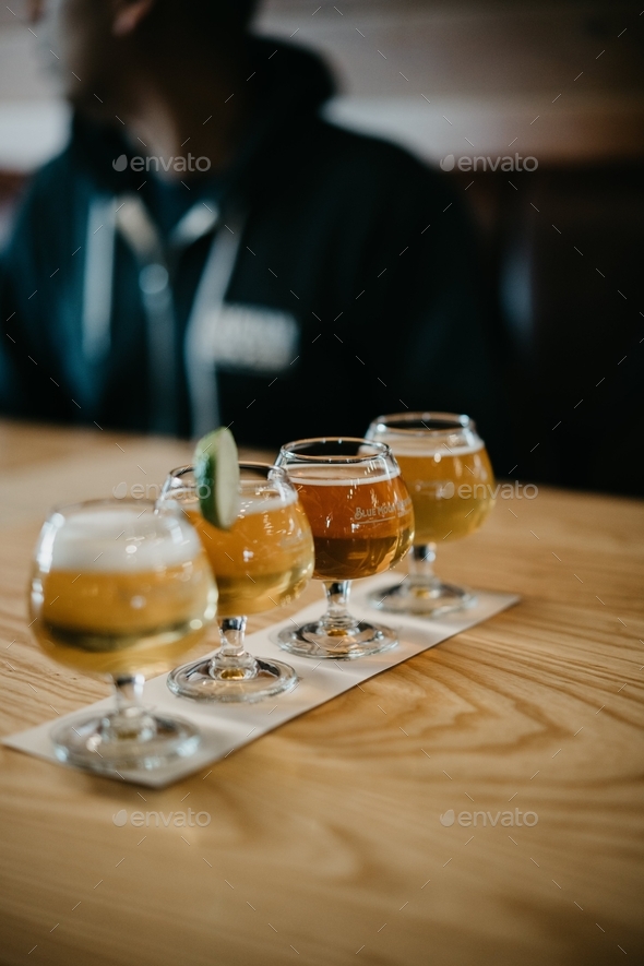 Beer tasters flight table restaurant drinking alcohol brewery bar Stock