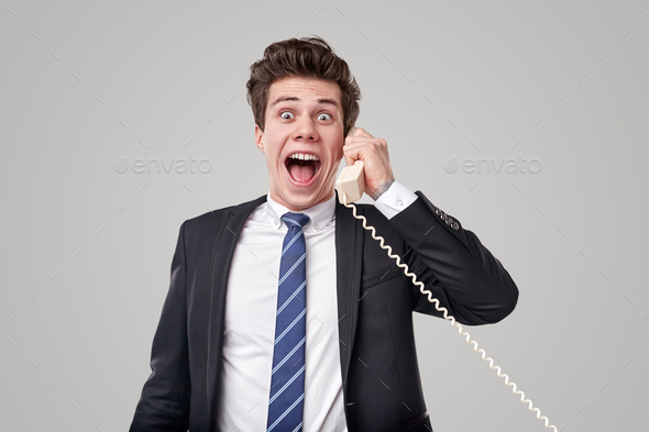 Happy worker talking on telephone with excitement