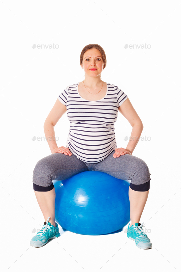 Pregnant woman doing exercises with exercise ball Stock Photo by Dmitry