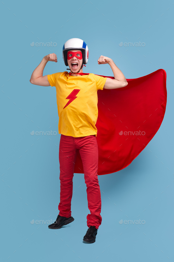 Strong comic superhero man showing biceps