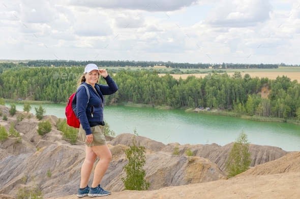 young woman plus size model in sportswear with backpack, in cap and ...