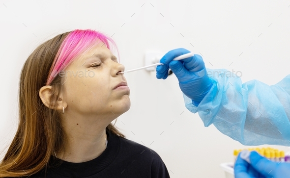 teenage girl passes PCR nose swab for covid-19 in laboratory, nurse medical worker laboratory