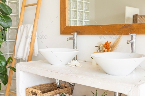 stylish and modern design bathroom interior with two white sinks, wicker baskets for cosmetics