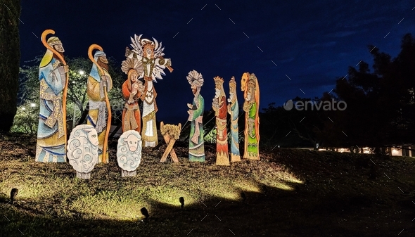 The birth of Jesus in lighted nativity scene at a church at nighttime in holiday decorating.