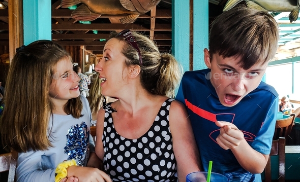 Generation z kids being kids in candids in public places in a restaurant in funniest photos.
