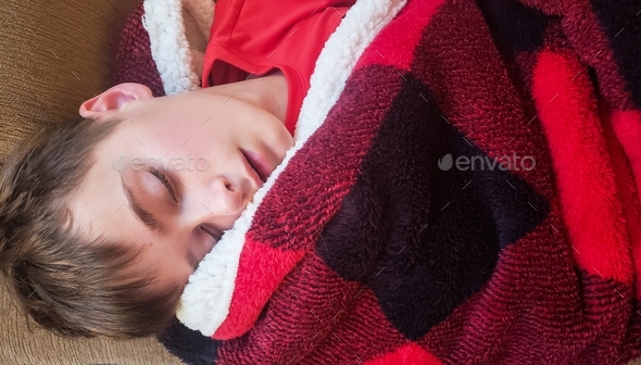 Little boy wrapped in a cozy blanket appears to be innocent but just wait til he wakes up before