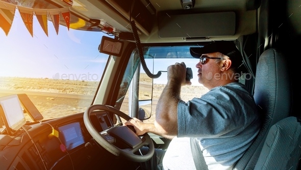 Truck drivers big truck right-hand traffic hands holding radio and steering wheel truck dashboard