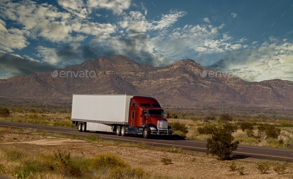 Classic big rig heavy duty long haul diesel semi truck with refrigerator semi trailer running on th