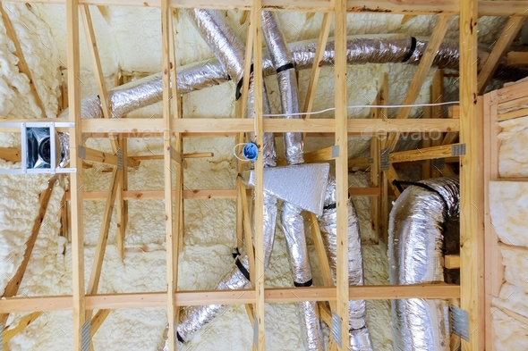 Thermal foam plastic insulation new home attic installation of HVAC tubing vents heating system on