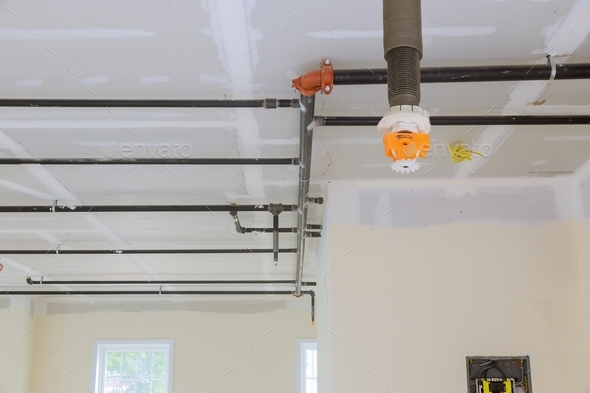 Automatic fire sprinkler system install on pipe ceiling background