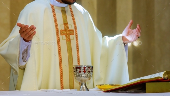 Holy communion on table in church cup of glass with red wine and bread, prayer for wine