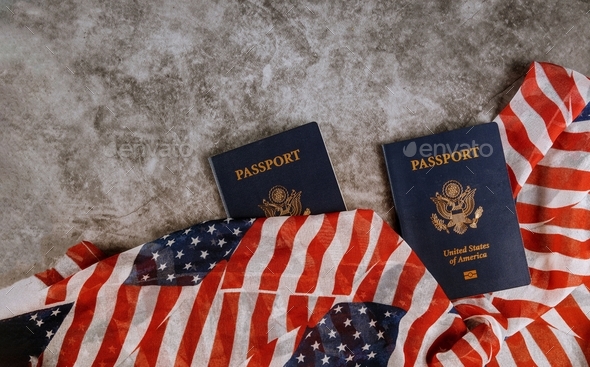 Passport of USA covered by American classic passport on US Flag. Personal documents on USA