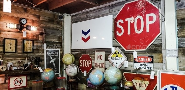 Old used road signs and traffic signs sold for home decor in antique retail store.