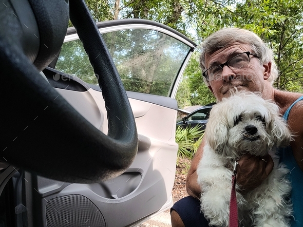 Active baby boomer and his dog arrive at their destination in the countryside.