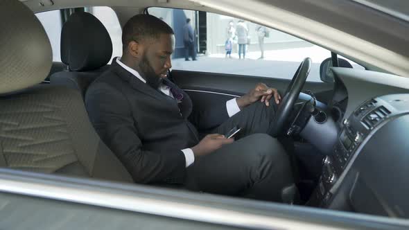 Chauffeur Sitting in Car Parked Near Airport Waiting for Arrival of Guests Plane alt