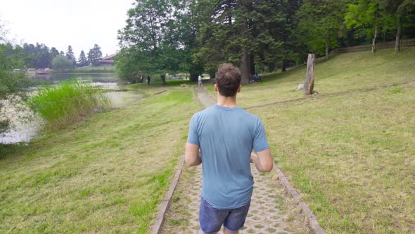Man jogging in nature park. alt