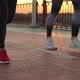 Legs of Sporty Women Jogging on Bridge at Sunset - VideoHive Item for Sale