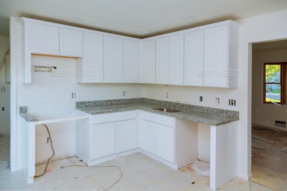 Installing new induction hob in modern kitchen kitchen Installation of kitchen cabinet.