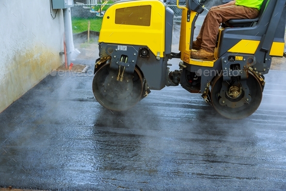 Road construction works with roller compactor machine and asphalt finisher parking for the car