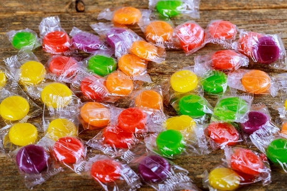 Top down macro of candy colorful candies on wooden background