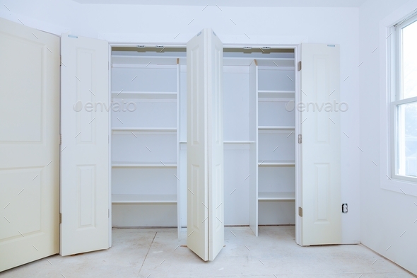 installation of shelves with a shelf near of big cabinet. Furniture installation.