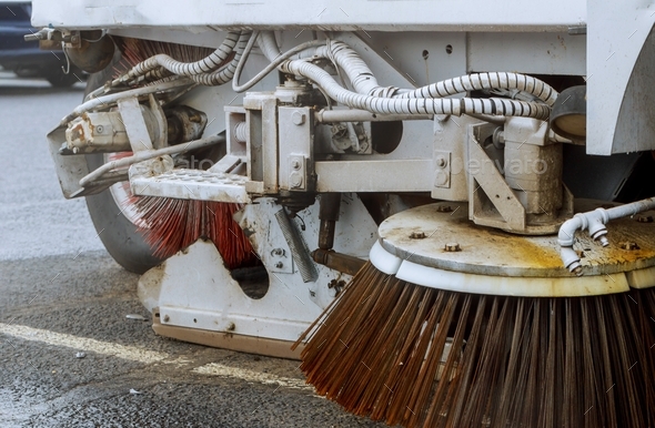 Part of a street cleaning vehicle car cleaning the road