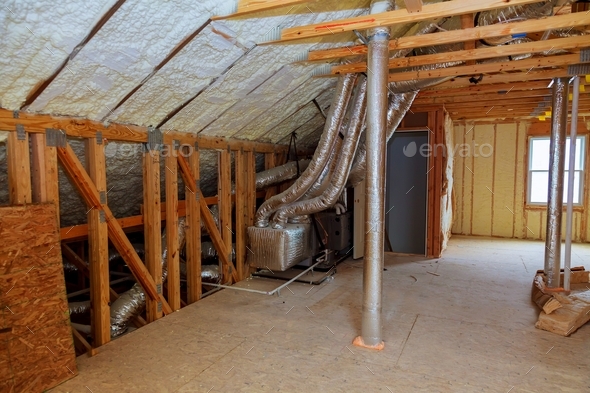 Foam plastic insulation installed in the sloping ceiling of a new frame house.