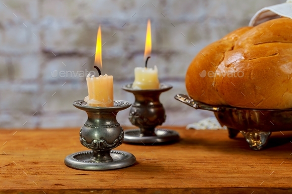Jewish holiday Sabbath Prayer Shawl Tallit table set for Shabbat with lighted candles