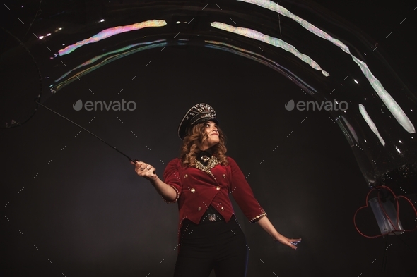 Theatrical soap bubble show from a young woman in a stage costume