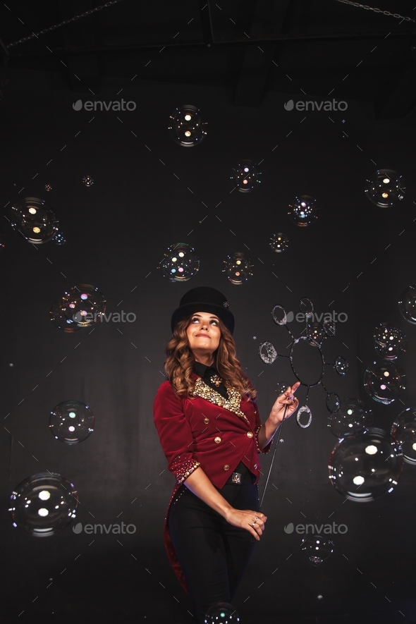 Theatrical soap bubble show from a young woman in a stage costume