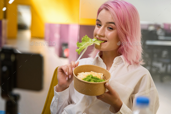 Happy lady having lunch in the office - Stock Photo - Images