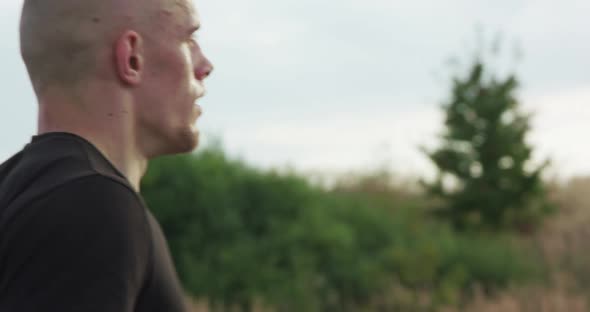 Profile View of Kickboxer Doing Fast Jumps on Skipping Rope on Nature alt