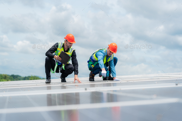 technician engineer working on checking maintenance service with solar batteries near solar panels
