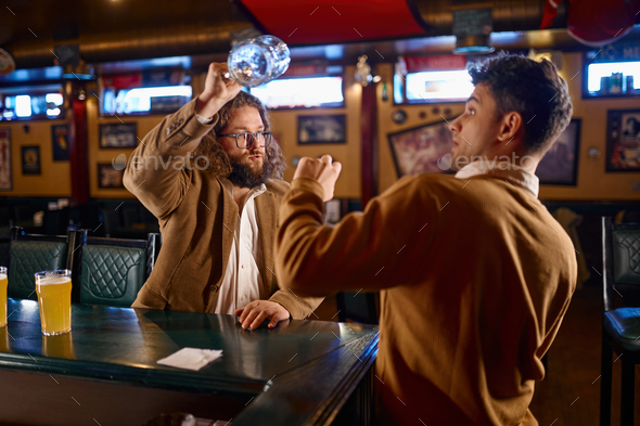 Unhappy furious men fighting at pub