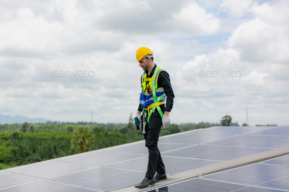 technician engineer working on checking maintenance service with solar batteries near solar panels