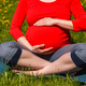 Pregnant woman doing asana Sukhasana outdoors - PhotoDune Item for Sale