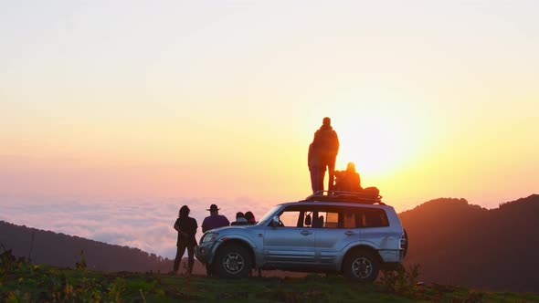 Tour Group Enjoy Sunset Above Clouds In Bakhmaro