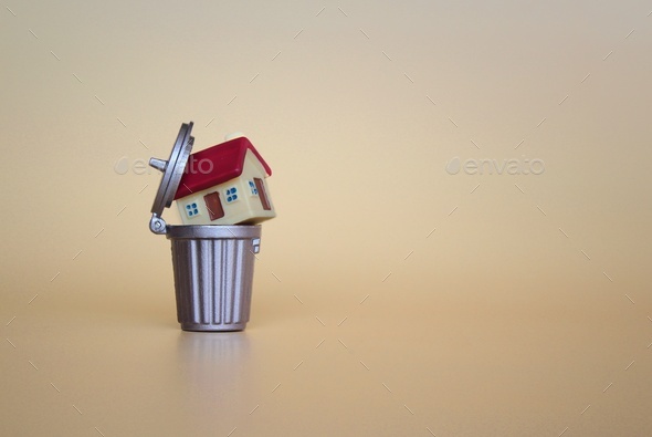 Throwing a home or a house into a trash can.