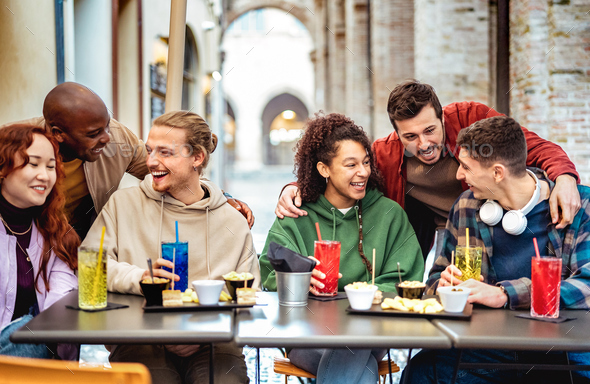 Multiracial trendy friends having fun moment at fancy cocktail bar - Stock Photo - Images