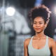 Portrait of beautiful and fit young African female with curly hair athlete training in gym clothes - PhotoDune Item for Sale