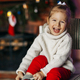 A beautiful little girl is smiling against the background of a Christmas room - PhotoDune Item for Sale