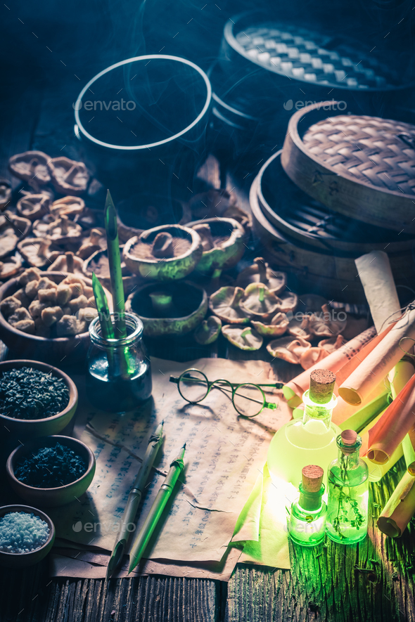 Unique research laboratory with recipe and old scrolls. Stock Photo by
