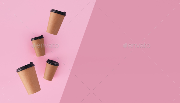 coffee paper cups with place for logo on pink background levitation