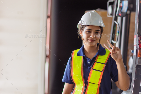 happy woman engineer worker Asian Latin Indian lady staff work in large factory warehouse