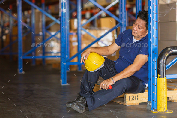 fatigue senior adult worker napping sleep at work exhausted. warehouse industry employee tied