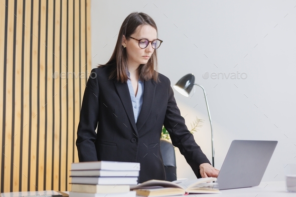 business woman is a business person or a company director in the office working with a laptop