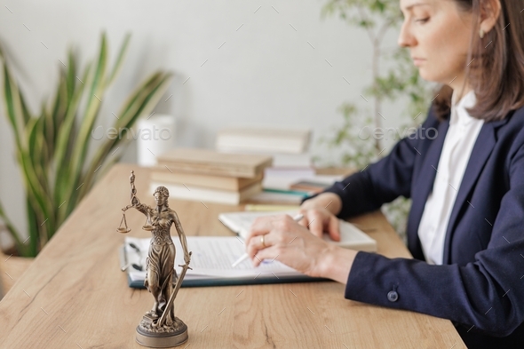 legal assistance during the period of self-isolation. a statuette of Themis, the goddess of justice.