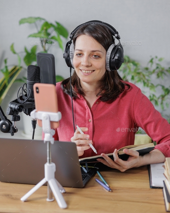 woman records audio content or a podcast for her blog in a home recording studio