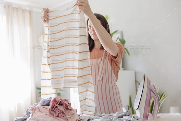  woman cleans clothes. cleaning or maid cleaning the house. Housework