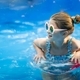 Stylish preteen kid girl swims with circle in pool. Funny child in pink glasses with shells  - PhotoDune Item for Sale